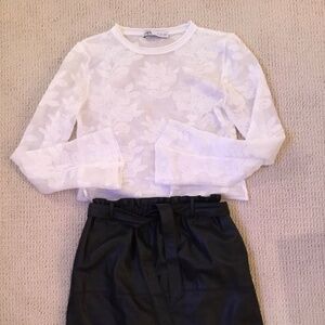 Faux leather skirt and white sheer top